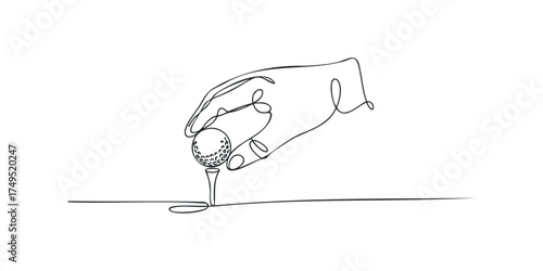 Hand places golf ball on tee