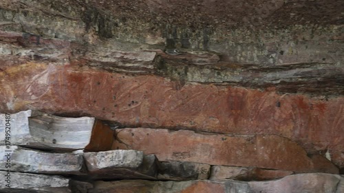 indigenous aboriginal rock art paintings at an ancient rocky outcrop along a hiking trail of Ubirr heritage site in Kakadu National Park, Arnhemland, Northern Territory, Australia.