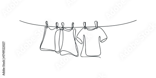 Three T-shirts drying on a clothesline with clips