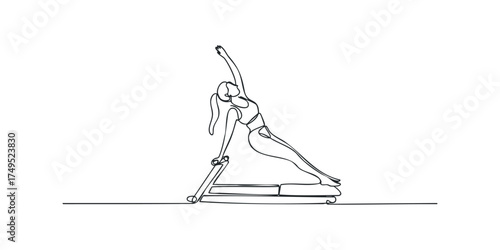 Woman performing pilates side bend exercise on reformer