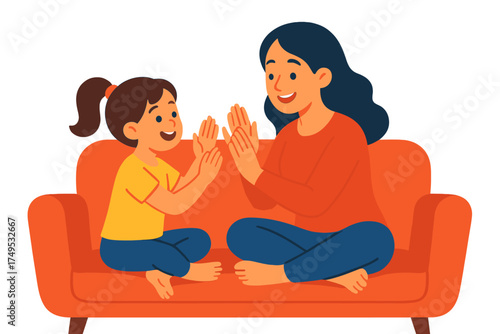 Mother and child playing hand clapping game while sitting on sofa