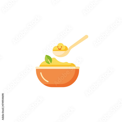 Cute baby food in bowl with a tiny green leaf, spoon of baby food. Nutritious first meal baby food concept for infants and toddlers.