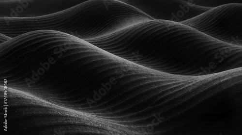 Black wavy fabric texture with soft dunes and flowing abstract pattern