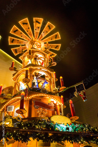 Traditional spinning  Christmas pyramid lit up at night, at Christmas market in Basel, Switzerland
