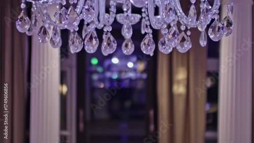 Elegant Crystal Chandelier with Glowing Lights in a Luxurious Interior Setting.