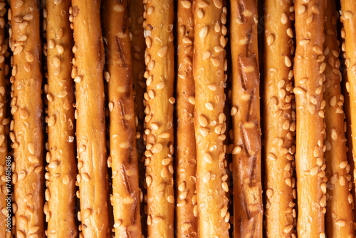 salted breadsticks with sesame seeds, close arrangement, baked snack