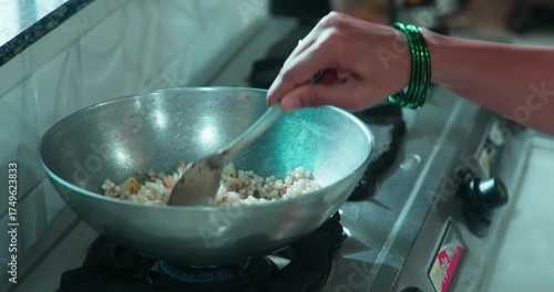 woman making sabudana dish for offering, and playful moment between couple with peanuts