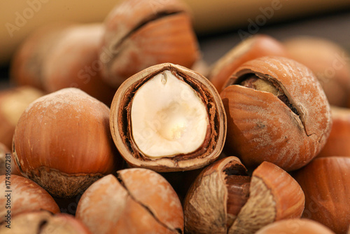 Hand-peeled hazelnuts with exposed kernels showing natural nut shells and meat for cooking and baking