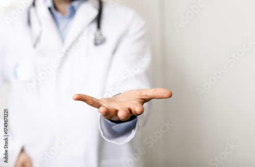 A doctor in a white coat ex...