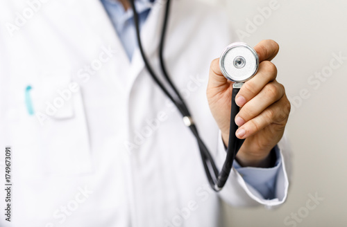A doctor holds a stethoscop...