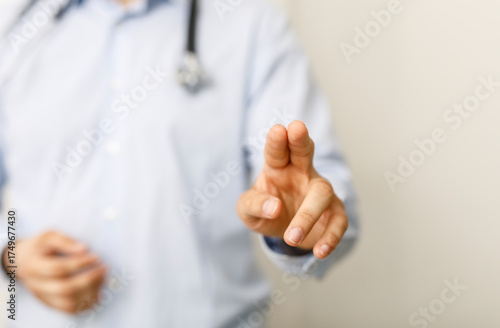 A doctor's hand pointing, c...