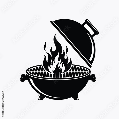 A black barbecue grill with open lid and flames a striking silhouette