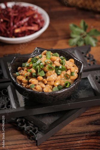 Japanese Natto Fermented Soybeans with Green Onions in Traditional Black Bowl on Wooden Tray