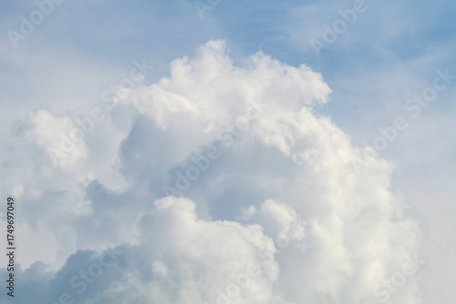 Fluffy white clouds floating under blue sky