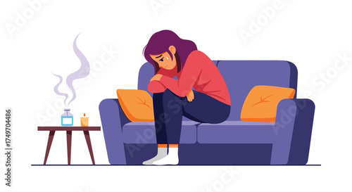 A person sits alone on a couch feeling sad and dejected.