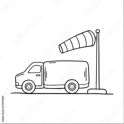 A windsock close to a fuel truck stationed near the tarmac