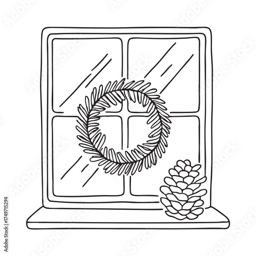 A wreath near a pinecone resting on a windowsill