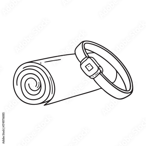 A wristband near a yoga mat rolled up