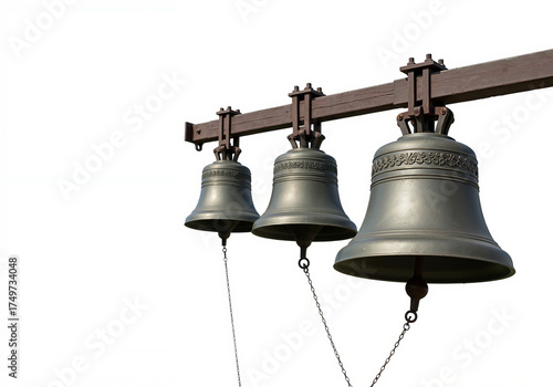 Three bronze church bells hanging and ringing on a frame against white background  