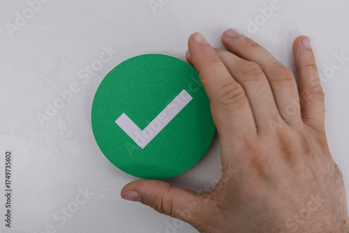 Person holding a green circ...
