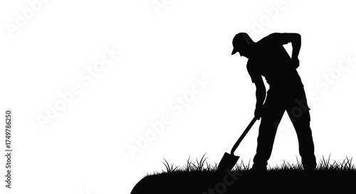 Silhouette of a farmer digging in the field with a shovel during daytime.