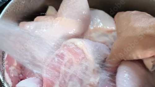 The chef is washing chicken thighs before cooking. Fresh Chicken Thighs Under Running Water Before Cooking Preparation