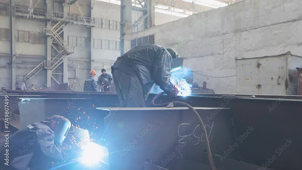 Welders welding large steel sections steel box girder of bridge ...