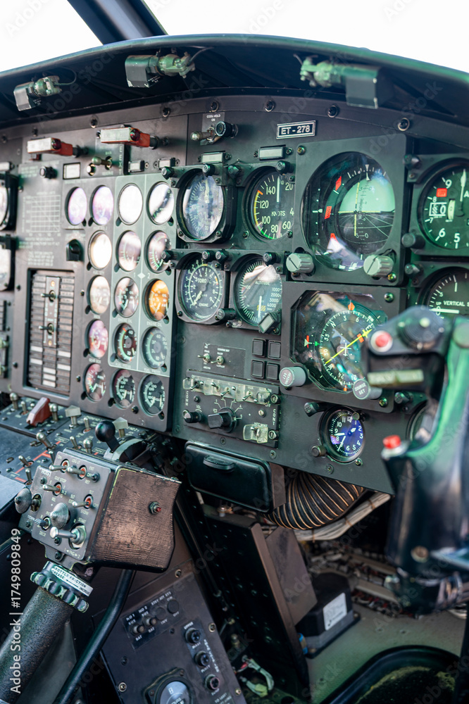 Fototapeta premium The cockpit of a helicopter is filled with gauges and controls. The pilot is in control of the aircraft and must be attentive to the various instruments and dials