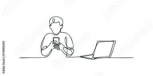 Person holding phone with laptop next to them