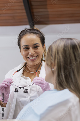 Female dentist smiling speaking with patient in clinic