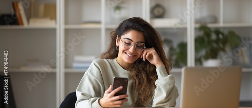 A young Indian girl uses her cell phone for business talk and job.