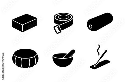Essential yoga equipment icons: simple black silhouette set