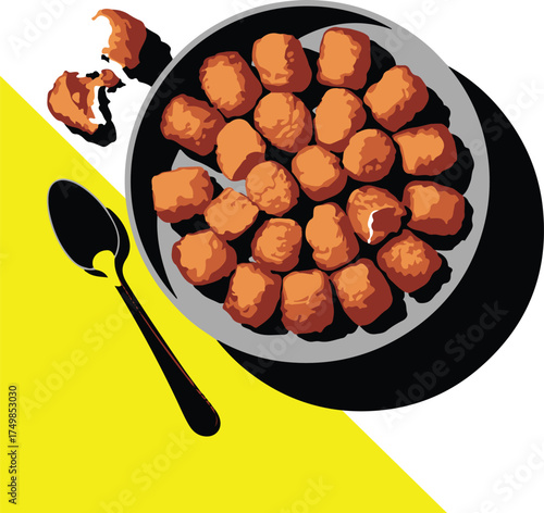 A top down view of chicken nuggets with a spoon and bowl
