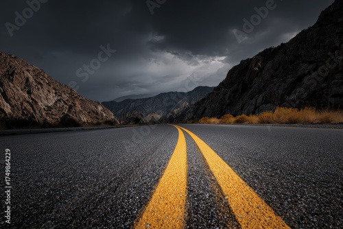 Road leading to a storm-darkened mountain pass