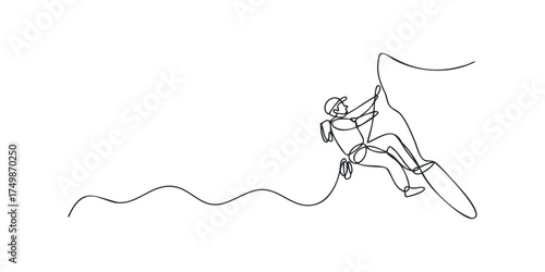 Person climbing steep rock face using rope