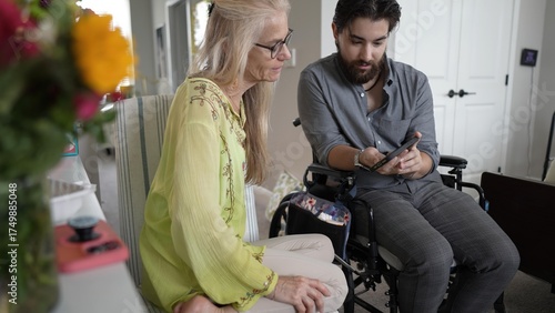 Quadro su tela Mother and Son Share Joyful Moments Through Smartphone Memories at Home