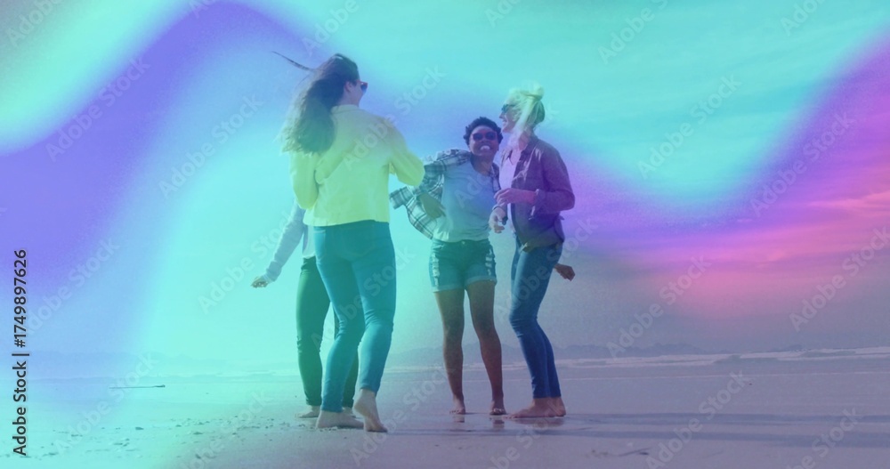 Naklejka premium Jumping four friends dancing in shallow beach water, with jeans, denim shorts and light jackets