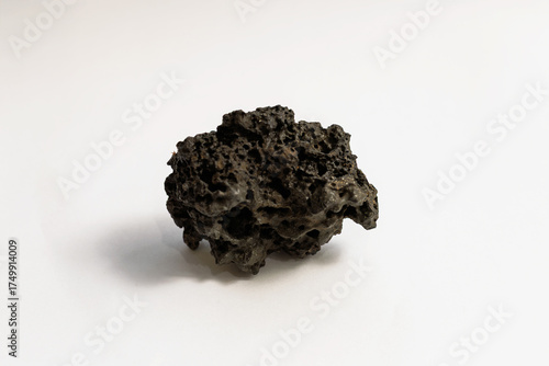 Canvas-taulu A small, dark piece of scoria lava rock from Tenerife, photographed on a white background