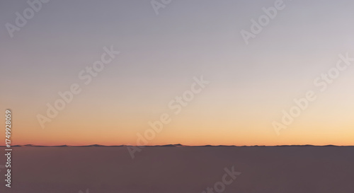 A soft gradient sky with a faint horizon line in muted pastel colors