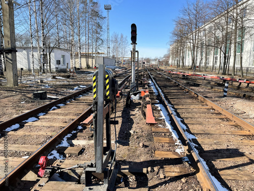 A train track with a yellow and black sign on it.