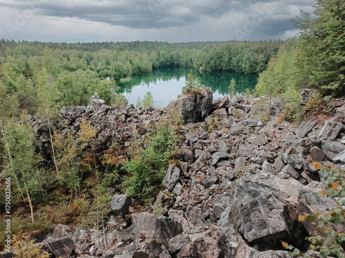 A rocky hillside with a lake in the distance