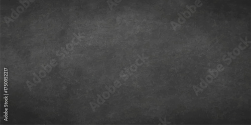 The vintage dark chalkboard has a rough, textured black surface, perfect as a blank grunge backdrop or old wall design