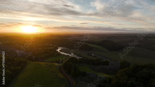 Sunset over Norham Castle and River Tweed from a drone, Norham, Northumberland, England