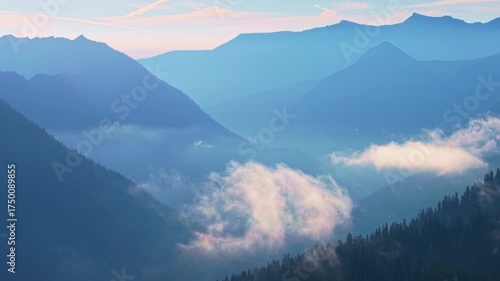 A stunning scenic aerial view showcasing the expansive Mt. Baker-Snoqualmie National Forest, with its lush landscapes illuminated under a sky of sunny clouds