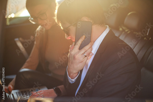 Corporate meeting of two employees in car for work and discussion of business