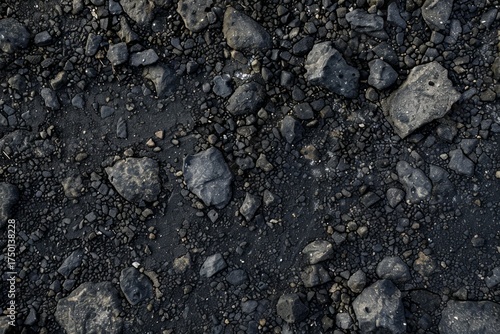 Photo of asphalt grey surface with stones. Background texture for backdrops or mapping