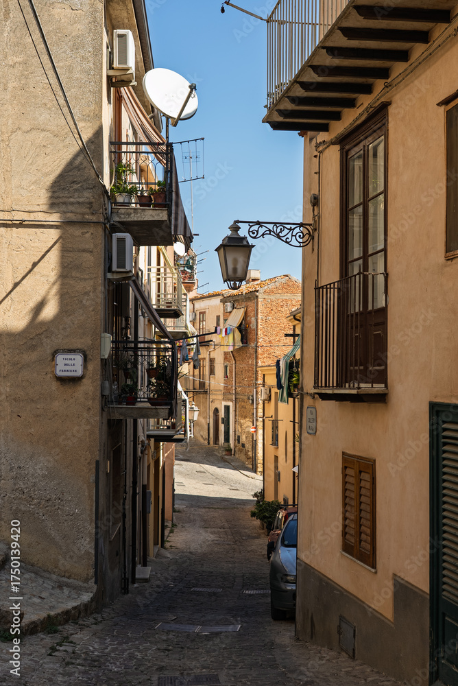 Fototapeta premium Castelbuono medieval town in the Madonie Mountains, Sicily, Italy, basking under the summer sun with historic streets, Ventimiglia Castle. Old mountain town in Sicily. Italian town in hills