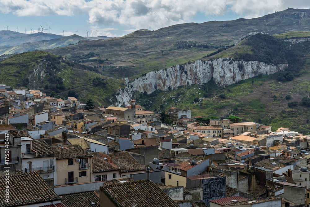 Naklejka premium Caltavuturo, a historic Sicilian mountain town in the Madonie Mountains, featuring its medieval castle, charming narrow streets, and traditional stone houses, Sicily, Italy. Italian town in hills