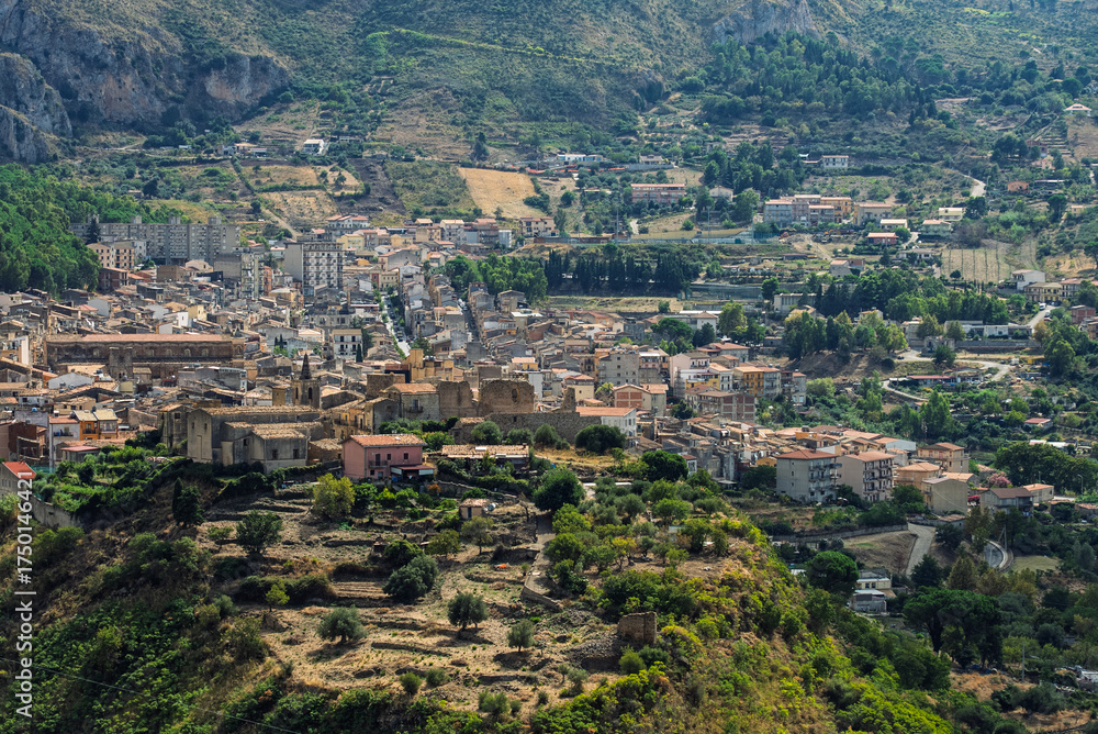 Fototapeta premium Collesano, a historic Sicilian mountain town in the Madonie Mountains, featuring narrow stone streets, traditional houses, and the Church of San Pietro, Sicily, Italy. Italian town in hills