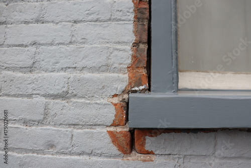 Old outdoor wall and repair window and bricks. Poorly insulated exterior wall and window repair. Old window and construction for repair.